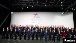 Leaders pose for a group photo during the Asia-Europe summit in Milan, Italy, October 16, 2014.