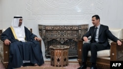 A file handout photo released on Jan. 13, 2009 shows Syrian President Bashar al-Assad, right, meeting with Abu Dhabi's Crown Prince Sheikh Mohammed Ben Zayed in Damascus. 