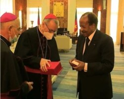 Cameroon President Paul Biya exchange gifts with Cardinal Pietro Parolin Yaounde, Jan. 29, 2021. (Moki Edwin Kindzeka/VOA)