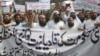 Pakistani Islamists protest against an appointment of a minority Ahmadi Muslim as an adviser to the government, in Lahore, Pakistan, Sept. 7, 2018. 