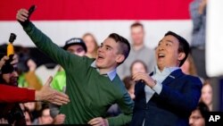 Democratic presidential candidate Andrew Yang takes a photograph with a member of the audience as he arrives at "Our Rights, Our Courts" forum New Hampshire Technical Institute's Concord Community College, Saturday, Feb. 8, 2020, in Concord, N.H. …