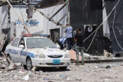 The morning after airstrikes hit a detention center holding migrants killed more than 50 people and injured at least 130, blood still stains the rubble as officials search for human remains, in Tripoli, Libya, July 3, 2019. (H. Murdock/VOA)