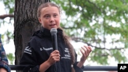 Greta Thunberg, a 16-year-old Swedish climate activist, speaks in front of a crowd of people after sailing in New York harbor aboard the Malizia II, Wednesday, Aug. 28, 2019. 