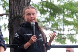 FILE - Greta Thunberg, a 16-year-old Swedish climate activist, speaks in front of a crowd of people after sailing into New York harbor aboard the Malizia II, Aug. 28, 2019.