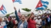 Demonstrators wave Cuban flags during a rally, Tuesday, July 13, 2021, in Miami. Demonstrators are protesting in solidarity with the thousands of Cubans who waged a rare weekend of protests around their island nation against the communist regime. …