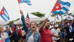 Demonstrators wave Cuban flags during a rally, July 13, 2021, in Miami.