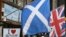 FILE - The Scottish Saltire flag (L) and the British Union flag are seen outside a shop in the centre of Edinburgh, Scotland on Sept. 12, 2014. 