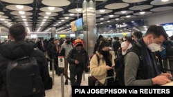 FILE - People queue at terminal 5 of Heathrow Airport, in London, Britain, Jan. 22, 2021, in this image obtained from social media. (Pia Josephson/via Reuters)