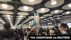 FILE - People queue at terminal 5 of Heathrow Airport, in London, Britain, Jan. 22, 2021, in this image obtained from social media. (Pia Josephson/via Reuters)