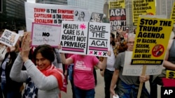 Protesters gather across the Chicago River from Trump Tower to rally against the repeal of the Affordable Care Act Friday, March 24, 2017, in Chicago.