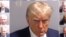 A combination picture shows police booking mugshots of former U.S. President Trump and the 18 people indicted with him