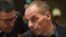 Greece's Finance Minister Yanis Varoufakis (R) speaks with a Greek delegation member an economic and financial affairs council (ECOFIN) at the European Council in Brussels, March 10, 2015.