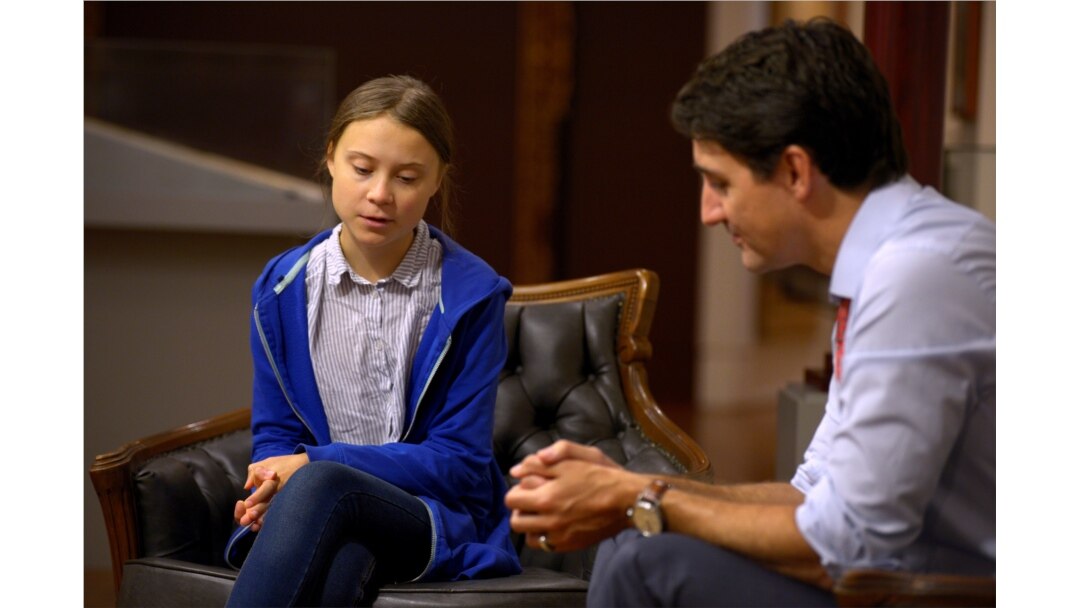 FILE - Canada's Prime Minister Justin Trudeau greets Swedish climate change teen activist Greta Thunberg before a climate strike march in Montreal, Quebec, Canada, Sept. 27, 2019.