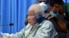 FLIE - Khieu Samphan, left, the former head of state for the Khmer Rouge, sits in a courtroom during a hearing at the U.N.-backed war crimes tribunal in Phnom Penh, Cambodia, Aug. 19, 2021.