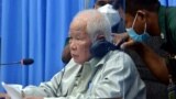 Khieu Samphan, left, the former head of state for the Khmer Rouge, sits in a courtroom during a hearing at the U.N.-backed war crimes tribunal in Phnom Penh, Cambodia, Aug. 19, 2021.