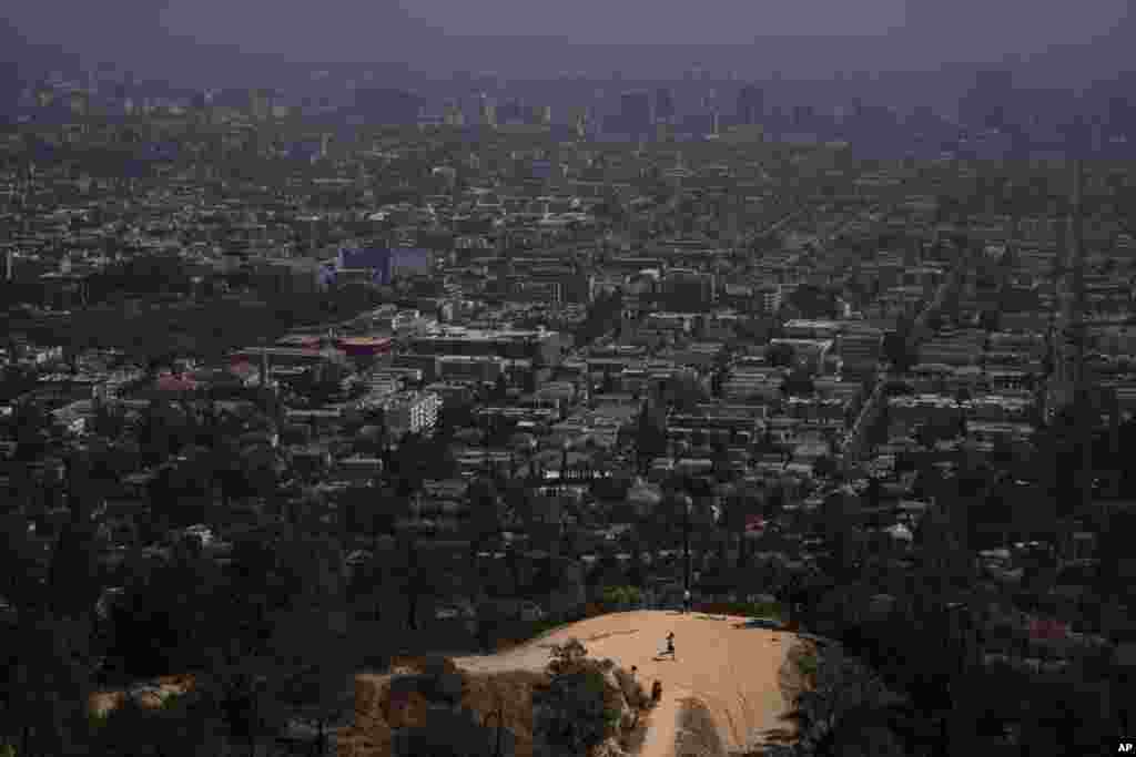 A jogger runs along a Griffith Park trail in Los Angeles, California, May 3, 2021.&nbsp;&nbsp;Los Angeles County is expected to move into the least-restrictive yellow tier this week, amid the coronavirus pandemic.