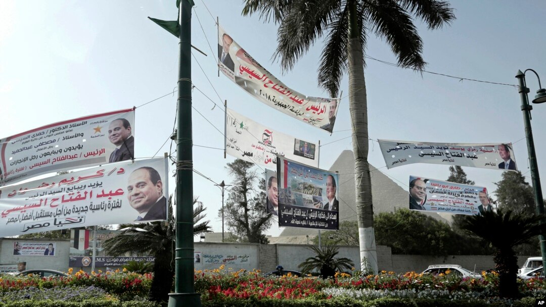 Election campaign banners for Egyptian presidential candidate President Abdel-Fattah el-Sissi hang in front of the Giza Pyramids, in Egypt, Monday, March 19, 2018. 