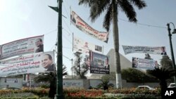 Election campaign banners for Egyptian presidential candidate President Abdel-Fattah el-Sissi hang in front of the Giza Pyramids, in Egypt, Monday, March 19, 2018. 