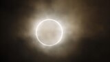 The moon slides across the sun, showing a blazing halo of light, during an annular eclipse at a waterfront park in Yokohama, near Tokyo, May 21, 2012.