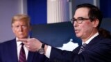 President Donald Trump listens as Treasury Secretary Steven Mnuchin speaks about the coronavirus at the White House, April 2, 2020, in Washington.