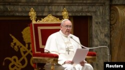 Newly elected Pope Francis I, Cardinal Jorge Mario Bergoglio of Argentina, meets cardinals in the Clementine Hall in a picture released by Osservatore Romano at the Vatican, March 15, 2013. 