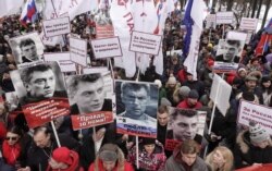 FILE - People attend a rally in memory of Russian opposition politician Boris Nemtsov, who was assassinated in 2015, in Moscow, Russia, Feb. 24, 2019.