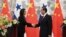 Panama's Foreign Minister Isabel de Saint Malo, left, shakes hands with her Chinese counterpart Wang Yi during a joint press briefing after signing a joint communique on establishing diplomatic relations, in Beijing, June 13, 2017.