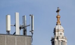Mobile network phone masts are visible in front of St. Paul's Cathedral in the City of London, Jan. 28, 2020. The Chinese tech firm Huawei will be given the opportunity to build non-core elements of Britain's 5G network, the government announced.