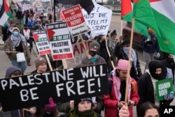 FILE — Pro-Palestinian demonstrators march during a visit by President Joe Biden in Warren, Michigan, February 1, 2024