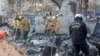 Rescue personnel look for hazards and remains at the site of a burned building during the Eaton fire in Altadena, California, Jan. 13, 2025. 