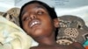 A child suffering from Japanese encephalitis rests on a hospital bed in the northern Indian city of Allahabad, September 18, 2005.