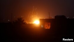 Fire is seen during fighting in the Islamic State's final enclave, in the village of Baghouz, Deir Al Zor province, Syria, March 17, 2019. 