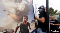 FILE - People protest in solidarity with Palestinians in Gaza, amid the ongoing conflict between Israel and Palestinian Islamist group Hamas, near the French embassy in Beirut, Lebanon, October 31, 2023.