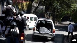 Police move the body of one of two slain journalists in Port-au-Prince, Haiti, Jan. 7, 2022. 