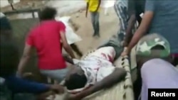 An injured man is carried on a stretcher during protests in Khartoum, Sudan, June 3, 2019 in this image taken from a video obtained from social media.