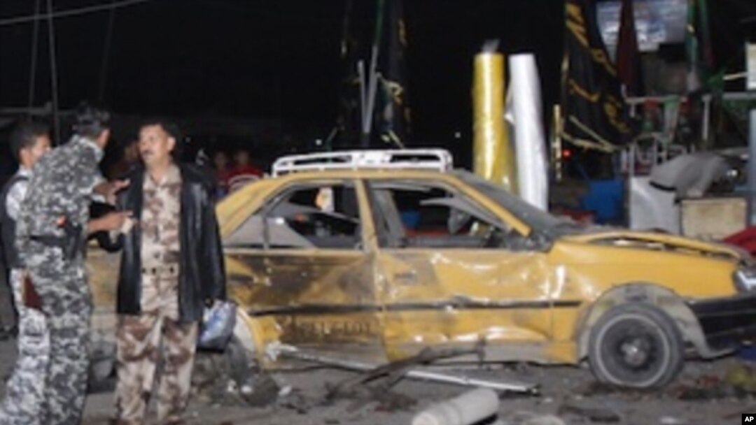 Security forces inspect the scene of a bomb attack in Basra, 550 kilometers southeast of Baghdad, Iraq, Thursday, Nov. 24, 2011.