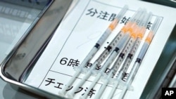 FILE - Syringes with the Moderna vaccine against COVID-19 disease for Tokyo Metropolitan Government employees are seen at a vaccination center, Japan, July 1. 2021.