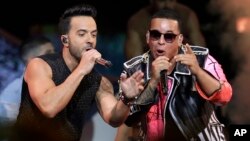 FILE - Singers Luis Fonsi, left and Daddy Yankee perform during the Latin Billboard Awards in Coral Gables, Fla., April 27, 2017. Malaysia has banned their hit song "Despacito" on state radio and television. The ban applies only to government-run radio and TV outlets, not to music streaming services or global entertainment providers like YouTube.