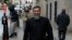 FILE - British Muslim cleric Anjem Choudary arrives at the Old Bailey in London for the start of his trial on Jan. 11, 2016. 