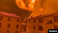 Flames rise above an apartment complex following an explosion in the Embakasi district, in Nairobi, Kenya, February 1, 2024. Screen grab taken from a social media video, Courtesy, Philip Awinyo Jeremiah via Reuters.