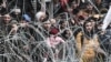 TURKEY -- This picture taken from the Greek side of the Greece-Turkey border near Kastanies, shows migrants waiting on the Turkish side on March 2, 2020.