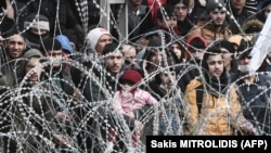 TURKEY -- This picture taken from the Greek side of the Greece-Turkey border near Kastanies, shows migrants waiting on the Turkish side on March 2, 2020.