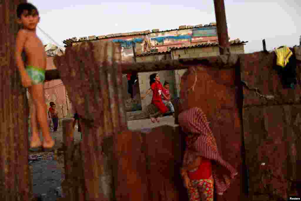 A Palestinian girl plays with a skipping rope outside her family house at Al-Shati refugee camp in Gaza City.