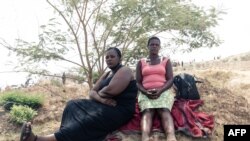 Relatives of trapped gold miners await news and watch the progress of rescue workers Ran Mine in Bindura, Zimbabwe, on Nov. 26, 2020.