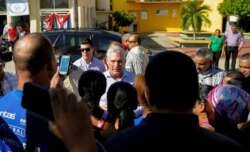Cuba's President Miguel Diaz-Canel visits with residents after arriving in Caimanera, Cuba, Nov. 14, 2019.
