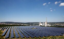 FILE - A general view shows solar panels to produce renewable energy at the Urbasolar photovoltaic park in Gardanne, France, June 25, 2018.