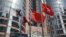 FILE - Flags are raised outside the Hong Kong Exchange Square building in Central of Hong Kong. 