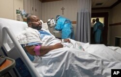 Cedric Daniels, 37, of Gonzales, La., rests in his room, recovering from COVID-19 at Our Lady of the Lake Regional Medical Center in Baton Rouge, La., Aug. 2, 2021.
