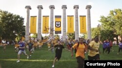 Students run across a part of the University of Missouri campus known as "The Columns" for an event called the "Tiger Walk."