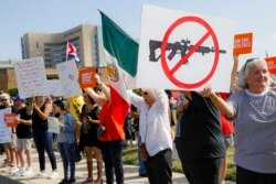 FILE - Demonstrators gather to protest after a mass shooting that occurred in Dayton, Ohio, Aug. 7, 2019.